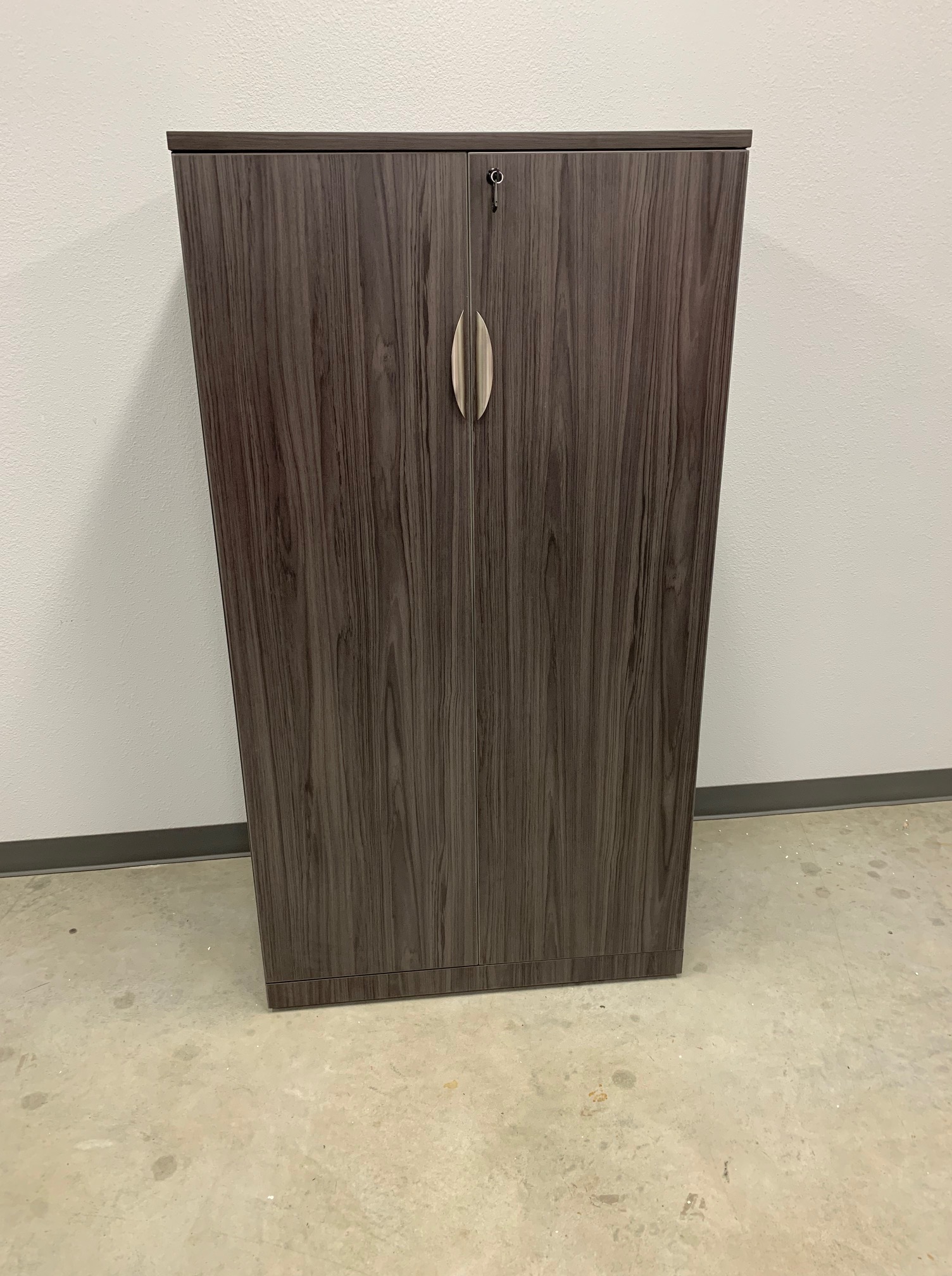 Gray driftwood-laminate locking storage cabinet with double doors