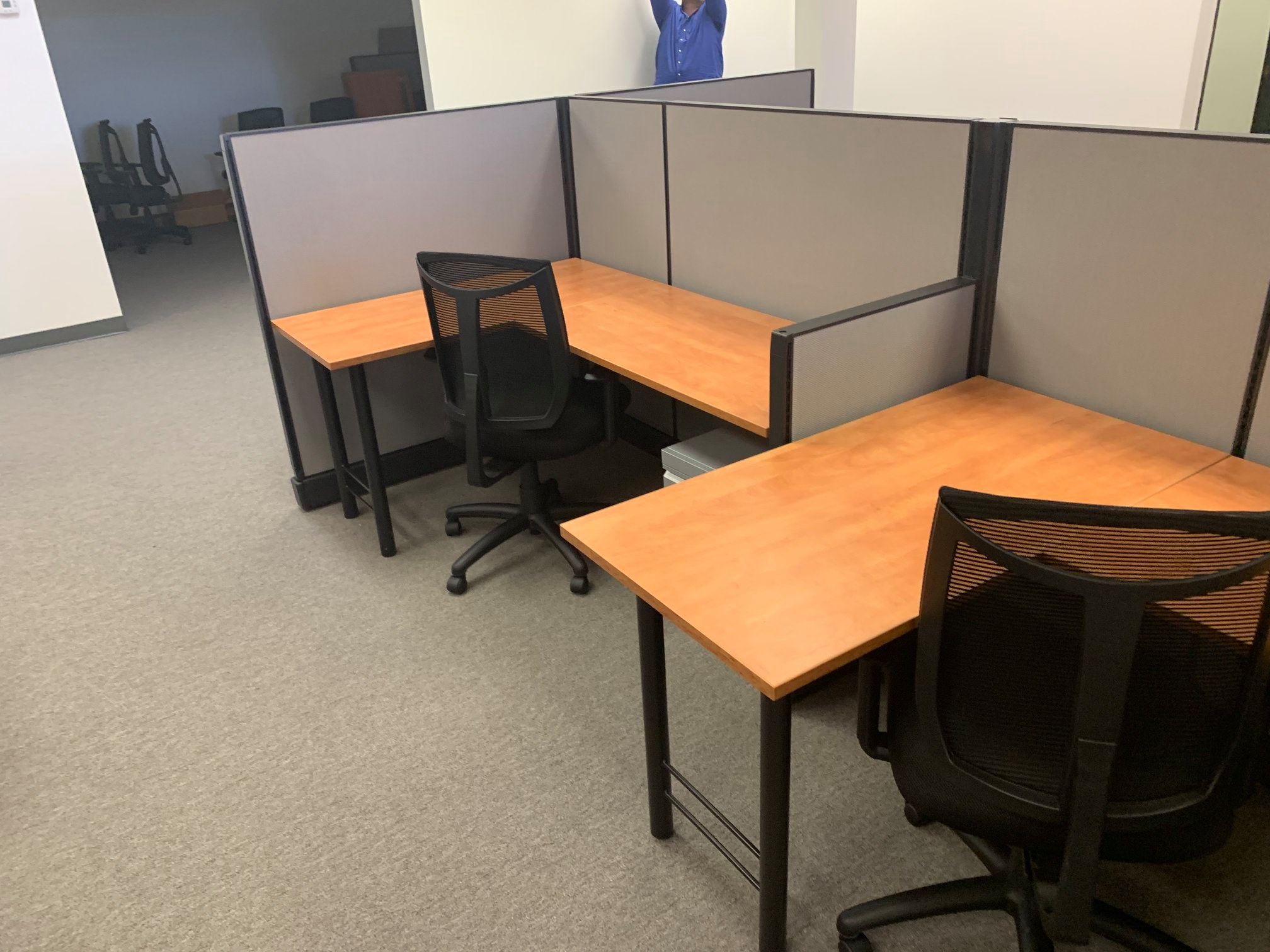 Compact L-shaped call-center workstations with maple worksurfaces and mesh chairs