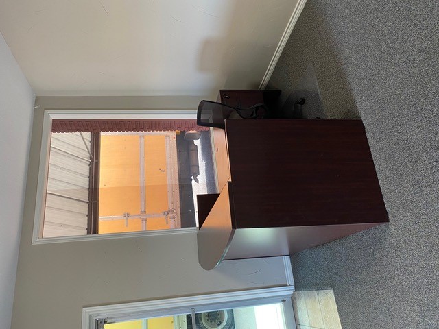 Mahogany reception desk with a transaction counter and task chair